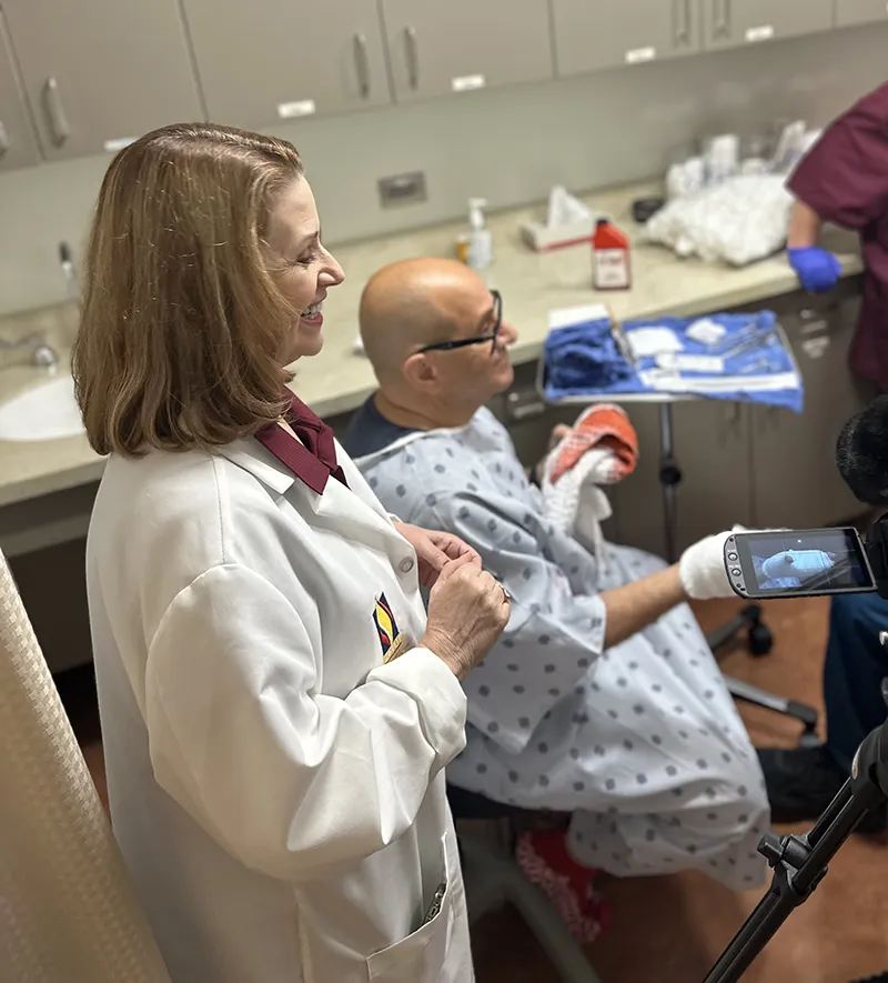 JoAnn Willette, the Manager of Clinical Simulation at PCOM Georgia, oversees a film session of a bandage training in the Simulation Center