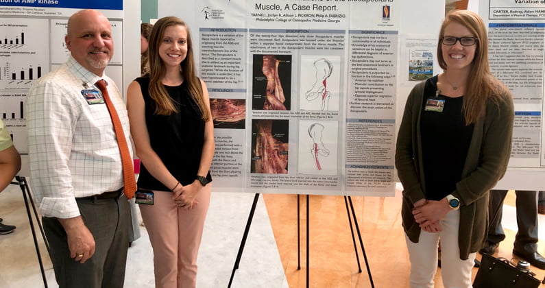 Allison Pickron (DPT ’21) and Jocilyn Yarnell (DPT ’21) pose with Philip Fabrizio, DPT, as they present their research poster at PCOM Georgia's annual Research Day.