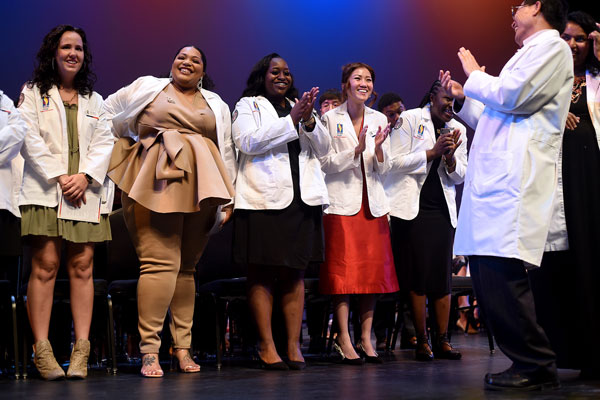 Pharmacy students on stage during white coat ceremony