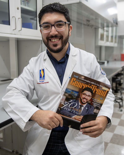 Charbel Aoun, MS ’21 (PharmD ’25) poses with the latest issue of Georgia Trend Magazine