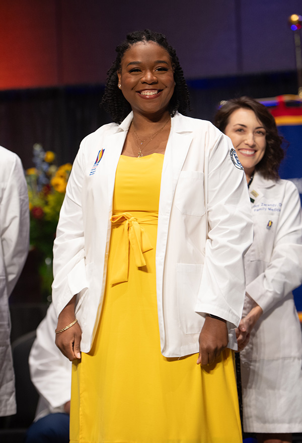 A PCOM Georgia female medical student smiles with her new white coat