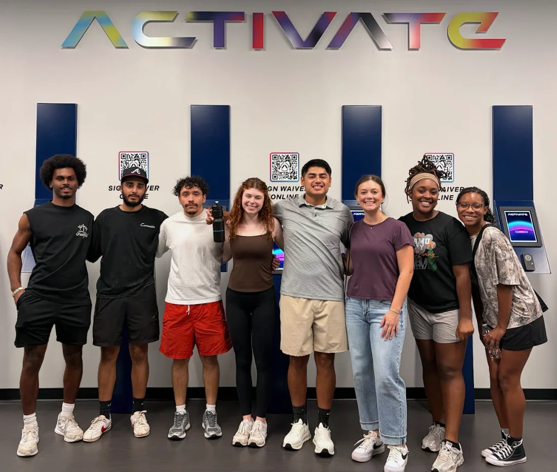 PCOM Georgia physical therapy student Jose Brian Palacios smiles with classmates in a physical therapy office during a rotation.