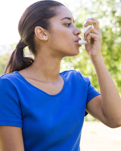 Woman using inhaler