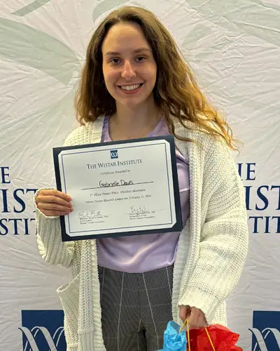 Gabrielle Davis poses with certificate for placing first in Research Symposium