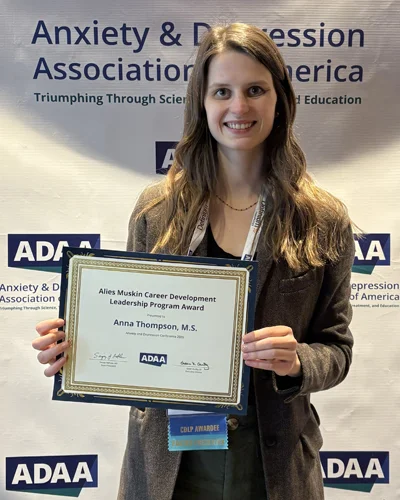 Anna Thompson (PsyD ‘28) holds an award certificate
