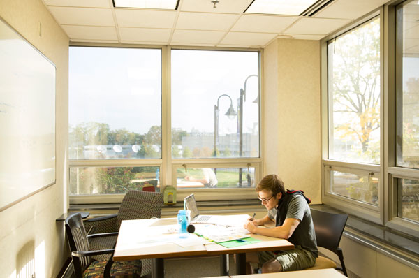 Grad student working on financial aid documents in the PCOM library
