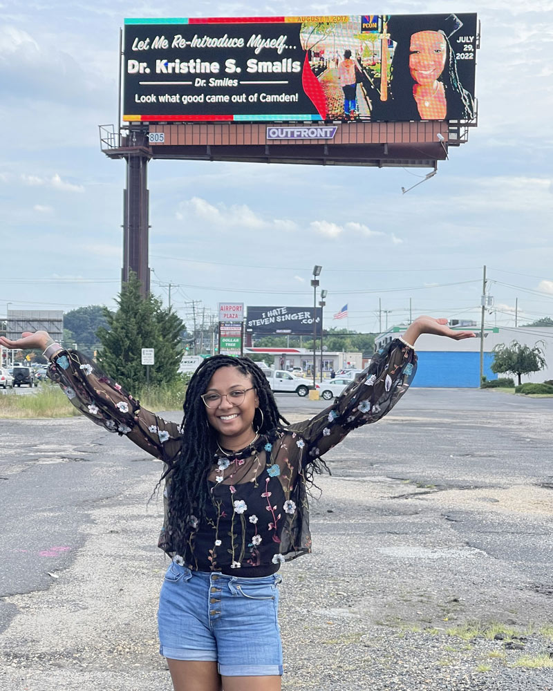 Kristine Smalls, PsydD '22, poses with her billoboard