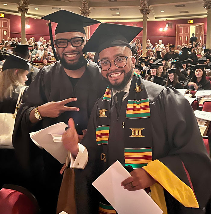 PCOM grad students smile inside the Academy of Music during the commencement ceremony