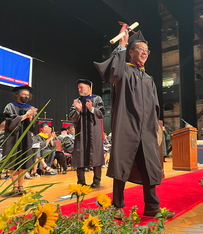 PCOM graduate and students receive their diplomas during the 2022 ceremony