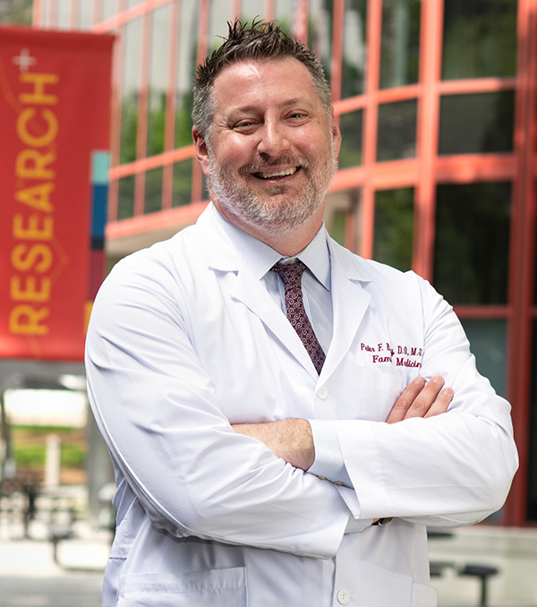 PCOM's new osteopathic medical program dean Peter Bidey, DO, smiling outside of PCOM's Philly campus