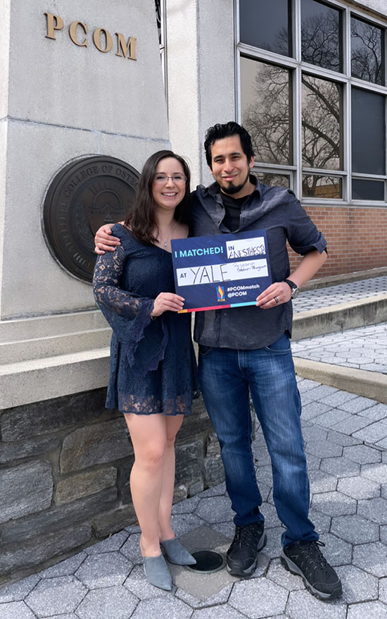 David R. Garcia Castro and his wife smile outside of PCOM's campus on Match Day