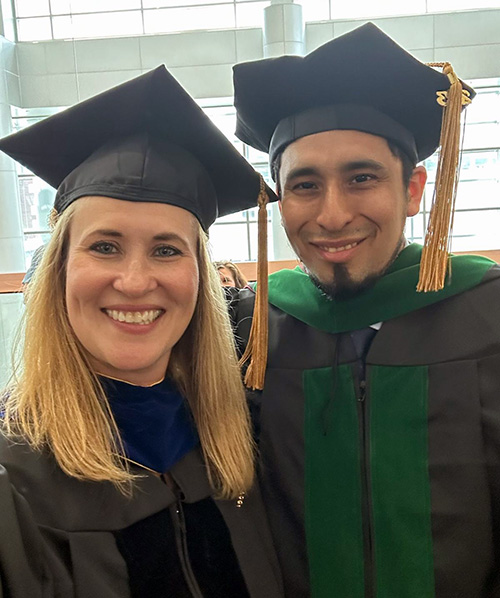 PCOM faculty member Heather Montie, PhD, and David Garcia Castro, DO, PhD '23, smile in their caps and gowns at commencement