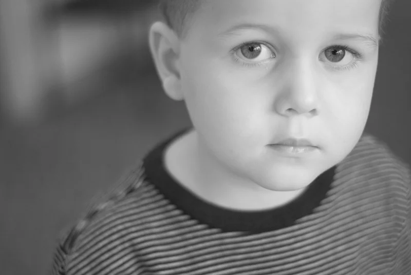 Black and white portrait photo of young cancer patient Dawson Nailor looking at the camera during treatment at CHOP. FOH/ALSF photo by David Simchock