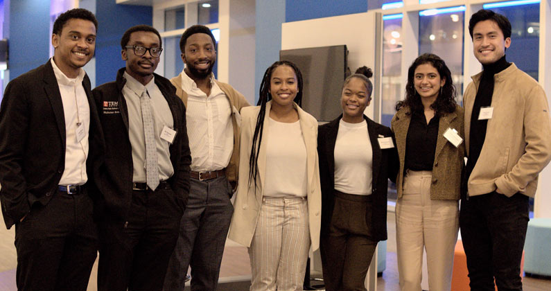 Carlo Comia (DO ’24) and fellow APEx Executive Board members pose for a group photo at the "Evening with Executives" event 