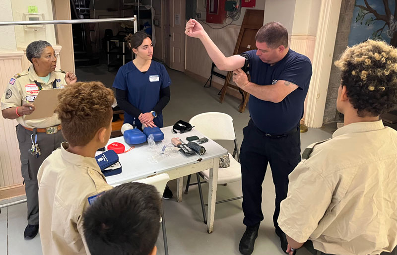 Young scouts watch as medical procedure is demonstrated