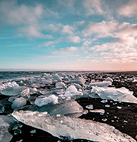 
 Photograph of an arctic beach with ice shelves radiating in the twighlight, by Cory German 
