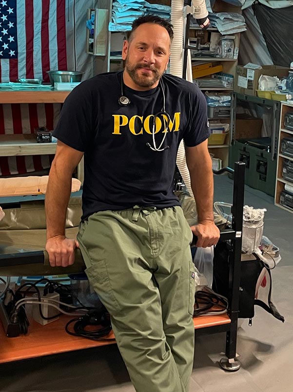 Dr. Bassett wears his PCOM t-shirt in Syria