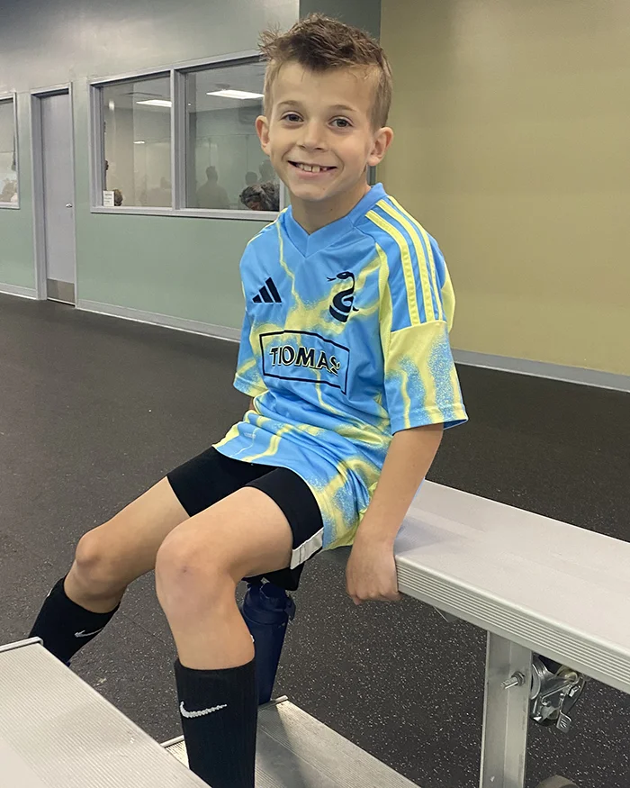A more recent photo of PCOM dean Missy Terlecki's son smiling in a soccer uniform