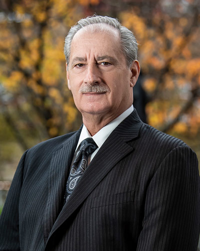 Professional headshot photograph of Alexander S. Nicholas, DO ‘75, FAAO dist.