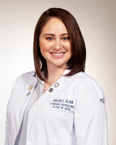 Professional headshot photograph of medical student Taylor Olian (DO '19) wearing her white coat.