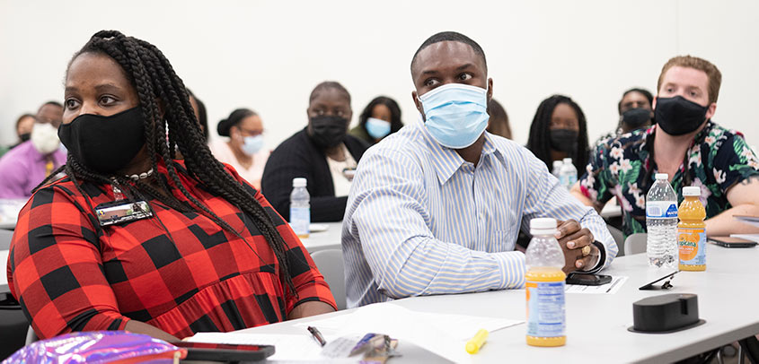 PCOM grad students listen during a lecture.