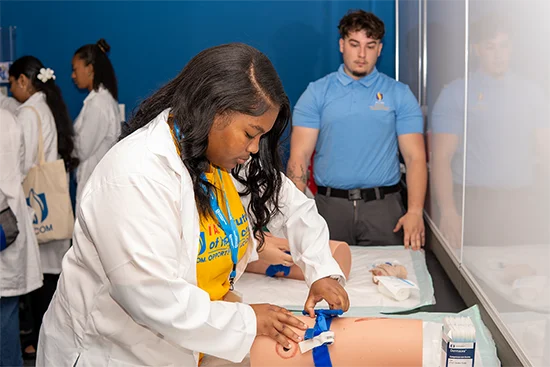 A student practices with a medical training tool