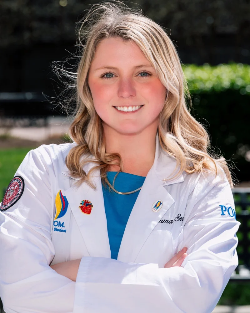 Emma Sevick (DO '28) poses with white medical coat
