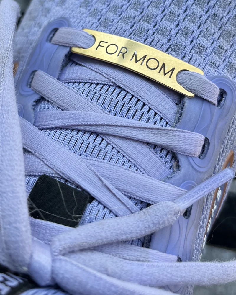 Closeup shot of sneaker with For Mom tag on shoe lace
