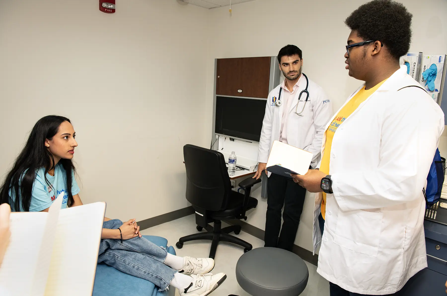 A participant in the opportunities academy interviews a mock patient.