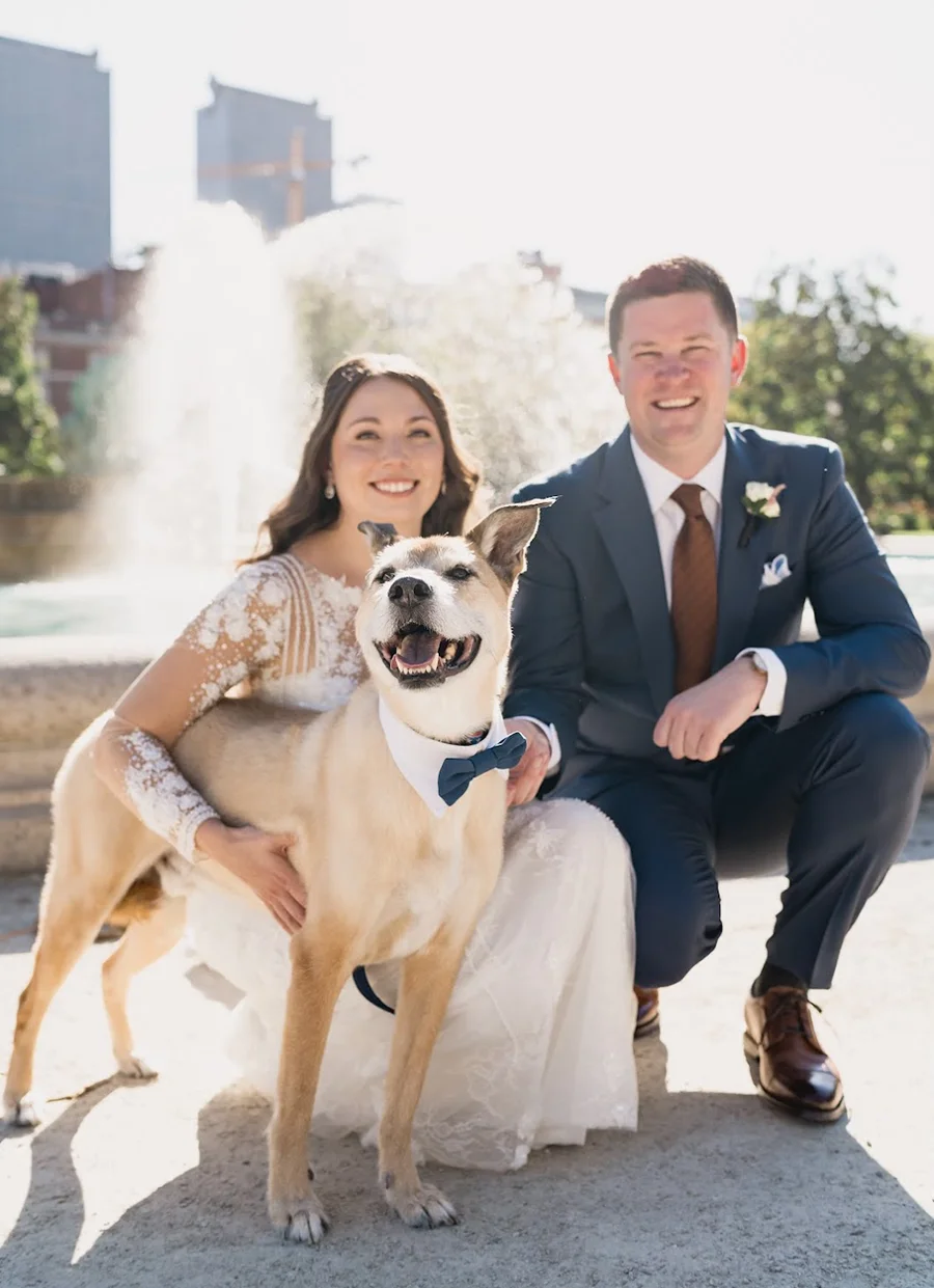 Dr. Worth smiling in a wedding photo with her husband John and their dog Tucker