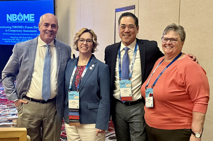 Dr. David Kuo smiling with a group of colleagues at an NBOME conference
