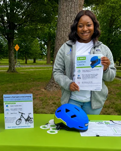 PCOM DO student Tiffany Jackson distributes educational materials on e-bike safety and helmet use