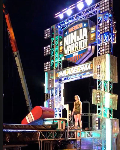 Female athlete and med student Megan Johnson (DO '22) stands at the starting line of an American Ninja Warrior obstacle course