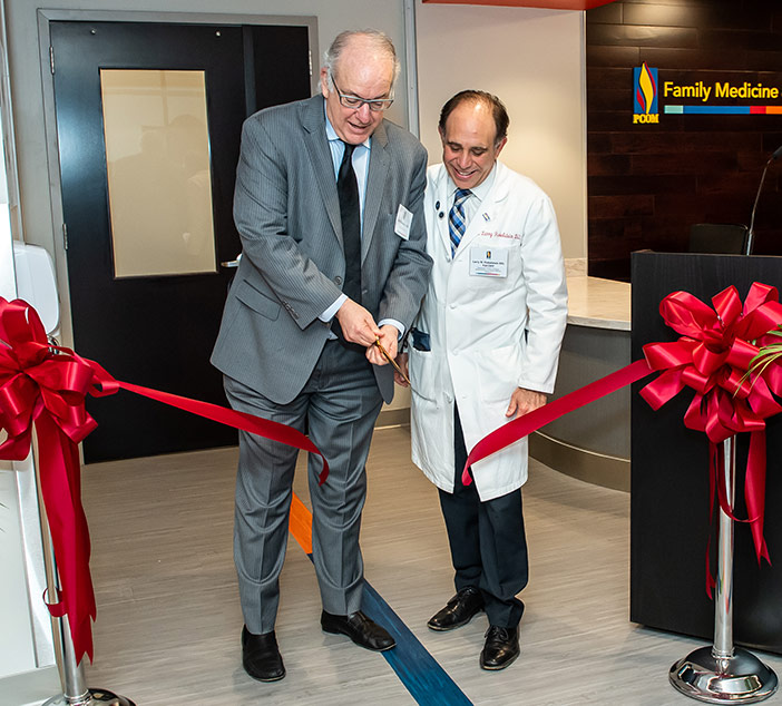 Jay Feldstein, DO, and Larry Finkelstein, DO, cut the ribbon for the newly-renovated PCOM Family Medicine suite