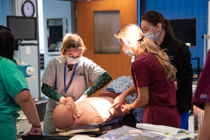 PCOM medical students practice surgical techniques on simulators