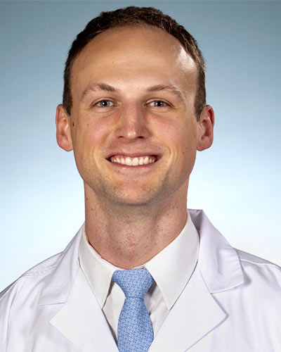 PCOM medical student David Cieremans, MS, smiling in a suit.