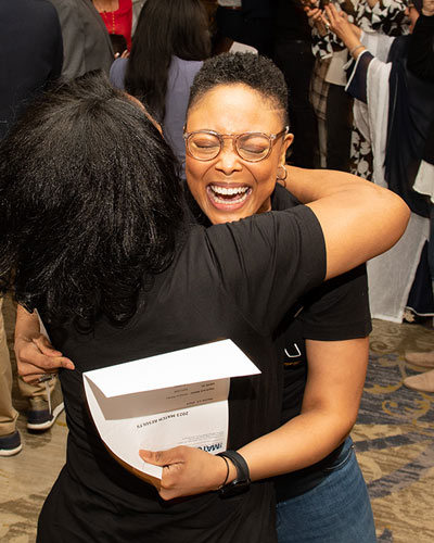 Overjoyed medical student hugs family member