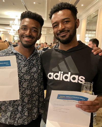 Med students pose with their Match Day envelopes