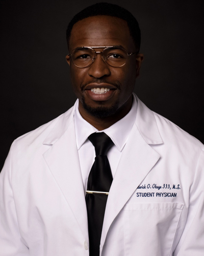 Headshot photo of PCOM med student Frederick Okoye (DO '24) wearing his student physician white coat