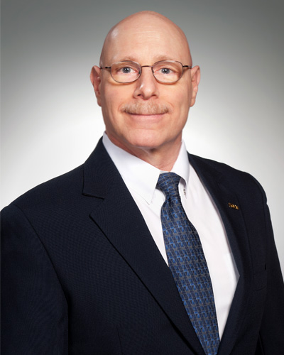 Professional headshot photograph of associate professor, clinical psychology, Brad Rosenfield, PsyD