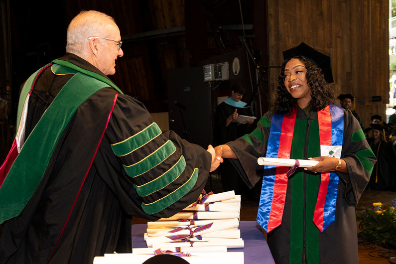 Dr. Feldstein presents diploma at commencement ceremony