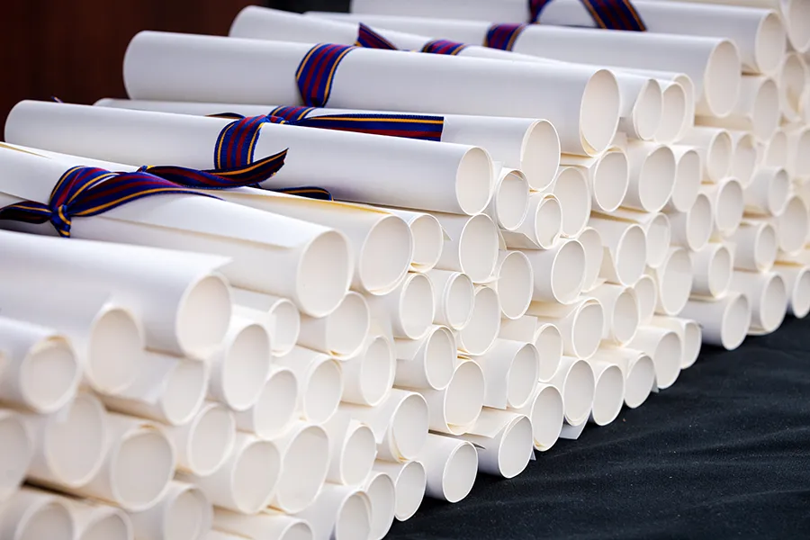 Macro photo of a stackof rolled up diplomas at a PCOM Georgia commencement ceremony