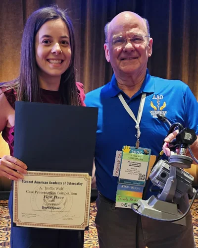 Lauren Lussier (DO ’27) and AAO rep pose together with award certificate