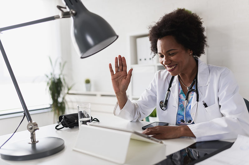 A physician speaks to a patient during a telemedicine appointment