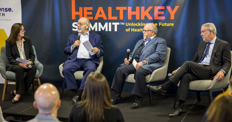Dr. Jay Feldstein shares the stage with panelists at the HealthKey Summit