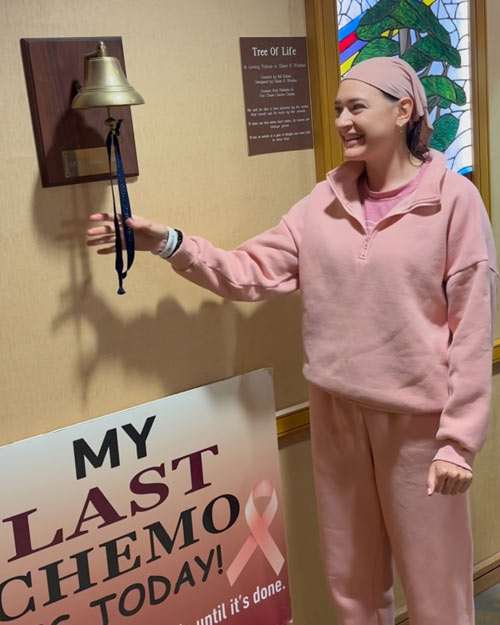 Angela rings a bell, signifying the end of her chemo therapy