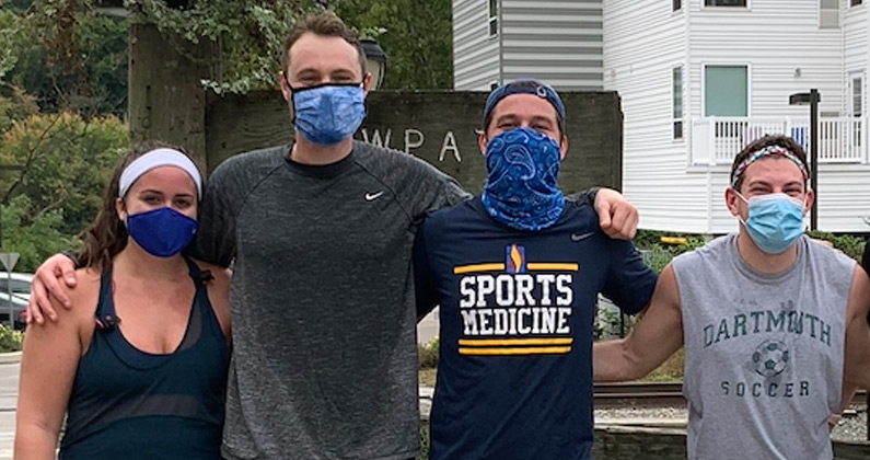 A few PCOM medical students wear face masks and smile after completing their personal 5K runs to help raise funds for PCOM's student-run health clinics in Philadelphia.