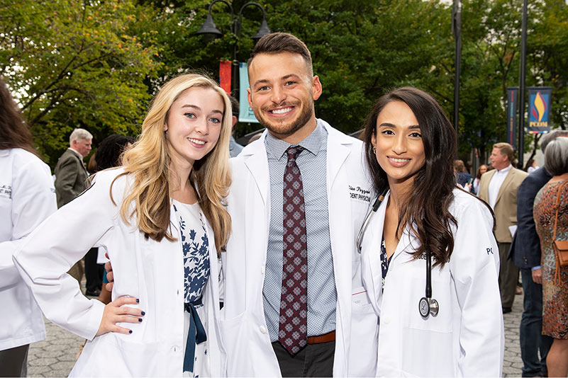 PCOM medical students smile outside at the annual white coat ceremony