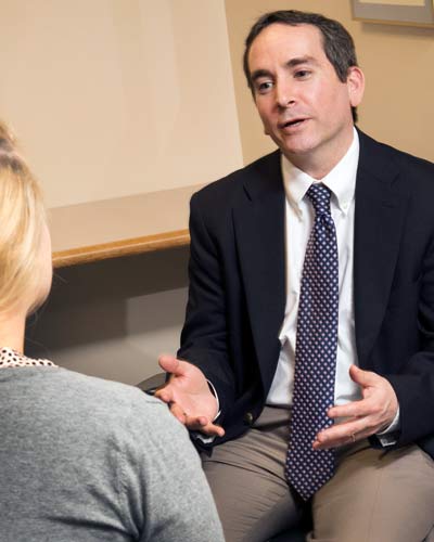 Dr. Scott Glassman counsels a patient in an office