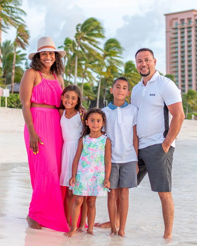 Dr. Leslie Fernandez on a beach with her husband and three children